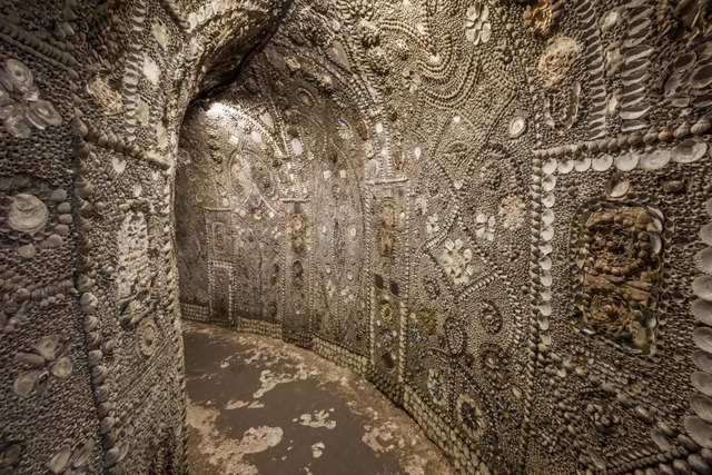 A close-up shot of the intricate, shell-lined walls of Shell Grotto.