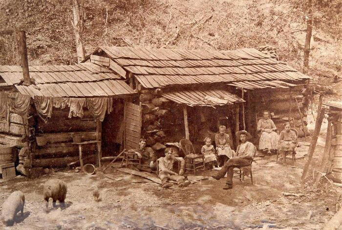 A family enjoying time together at their cabin home in West Virginia, 1900.