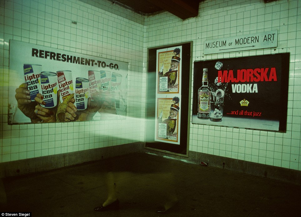A ghostly shot captures a woman, perhaps coming from a MOMA visit, with only her feet visible as she walks through the eerie subway tunnel.