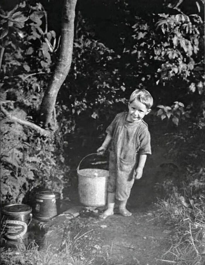 A mountain boy fetching water from a spring in the Great Smoky Mountains, Tennessee, circa 1950.