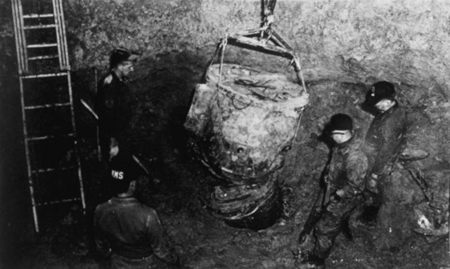 Air Force personnel work in an underground pit to recover parts of the Mk 39 nuclear bomb after the Goldsboro accident.