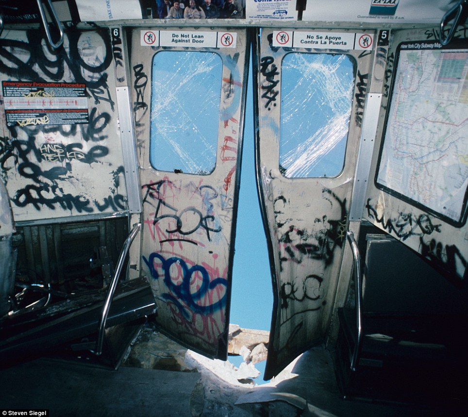 In a Jersey City scrapyard, Siegel photographs retired subway cars being sent to their final resting place after their service to the MTA.