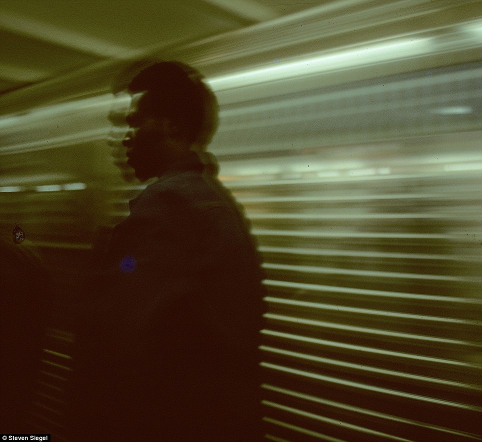 In a split second, a man on the platform is caught by Siegel as the subway rushes by, creating a sense of urgency and motion.