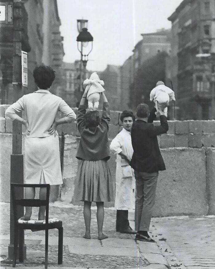 Residents of West Berlin introduce their children to their grandparents in East Berlin, 1961.