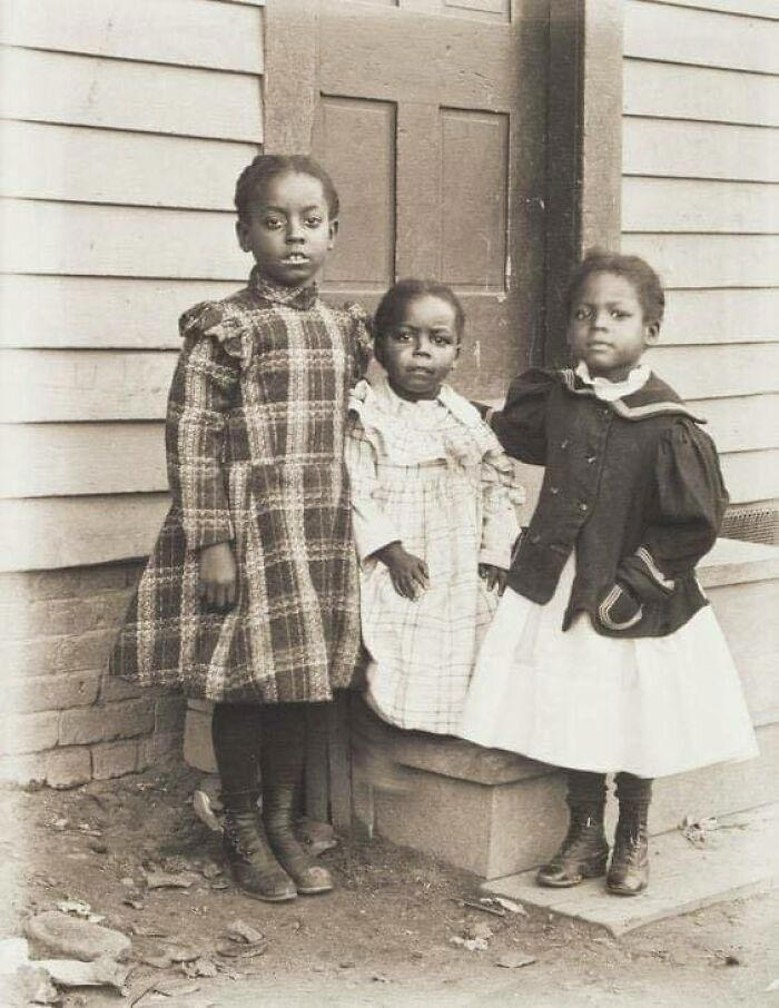 Three beautiful children from the early 1900s, captured in a timeless photograph.