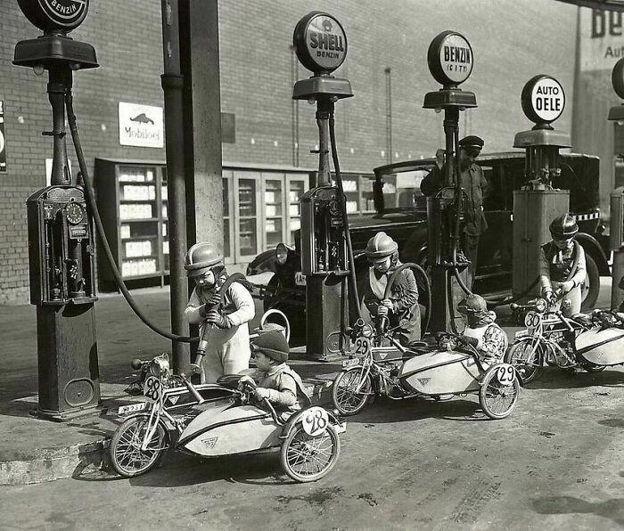 Young riders take a quick refuel break during a children’s sidecar race in Lustgarten, Berlin, 1931.